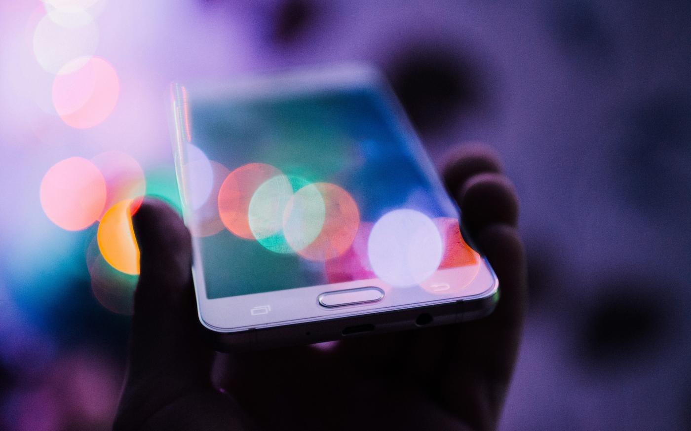 person holding smartphone by Rodion Kutsaiev courtesy of Unsplash.