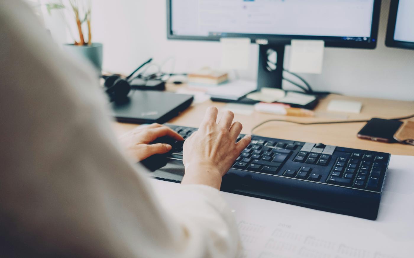 a person is typing on a computer keyboard by Daniel Enders-Theiss courtesy of Unsplash.
