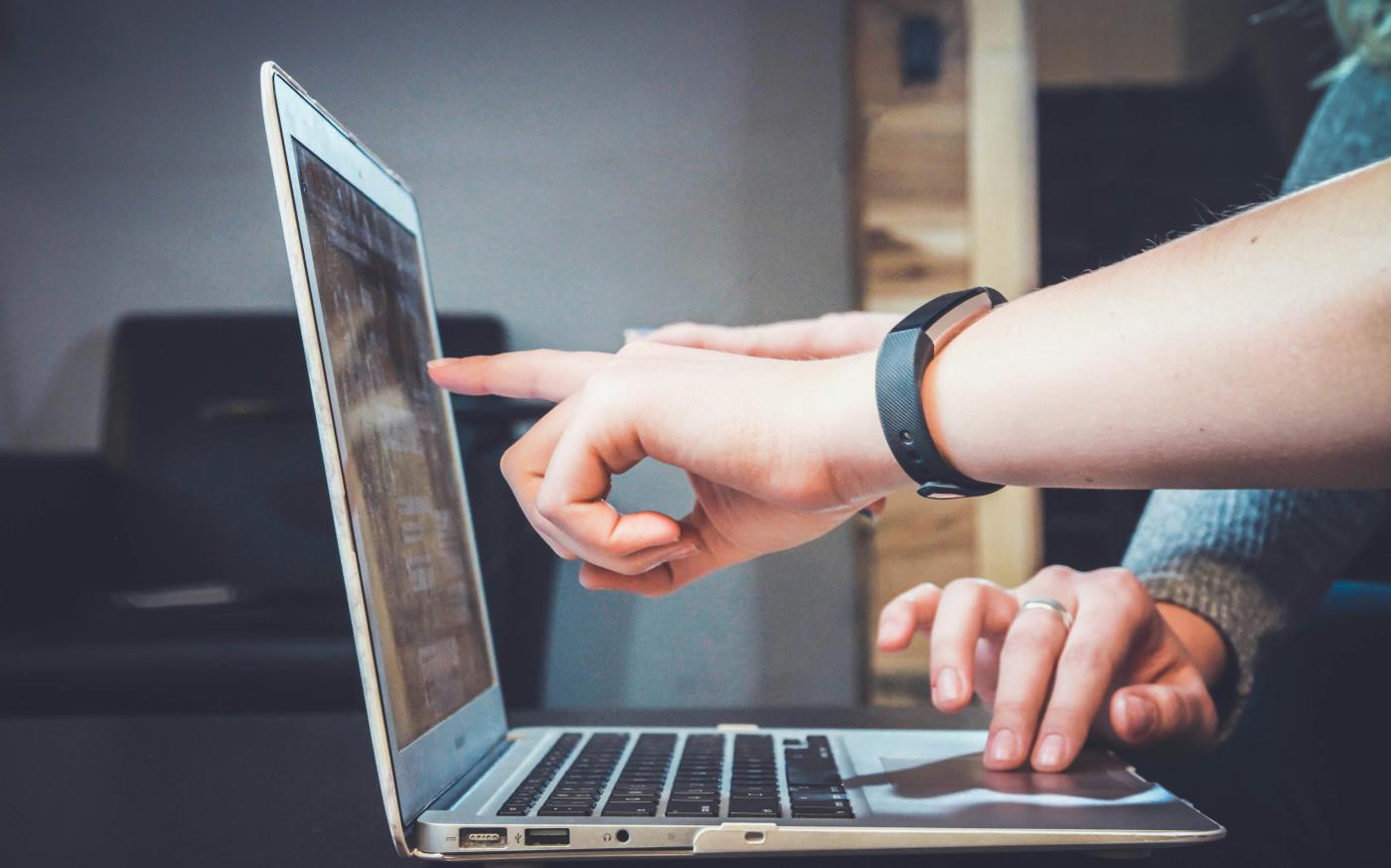 person using laptop by John Schnobrich courtesy of Unsplash.