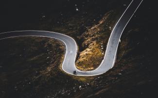 aerial view of gray asphalt road by Marek Piwnicki courtesy of Unsplash.