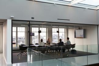 people sitting on chair inside building by Rodeo Project Management Software courtesy of Unsplash.