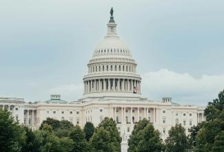 A view of the capitol building from across the water by Connor Gan courtesy of Unsplash.